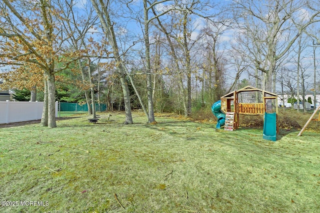 view of yard featuring a playground and fence