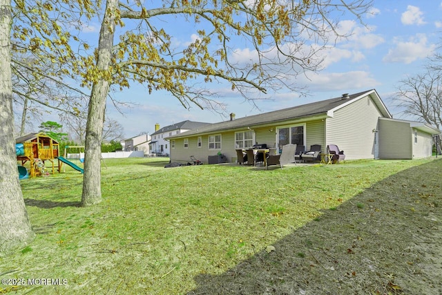 back of house with a playground, a lawn, fence, and a patio