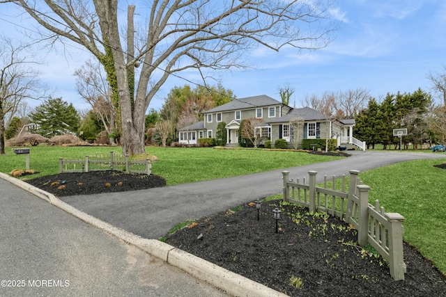 view of front of property with a front yard and driveway