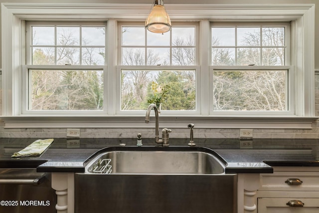 kitchen with a sink and dark countertops