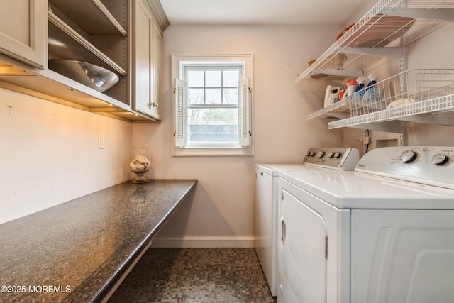 washroom with baseboards and washer and clothes dryer