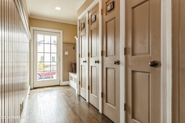 doorway to outside featuring dark wood finished floors and ornamental molding