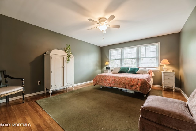 bedroom featuring ceiling fan, baseboards, and wood finished floors