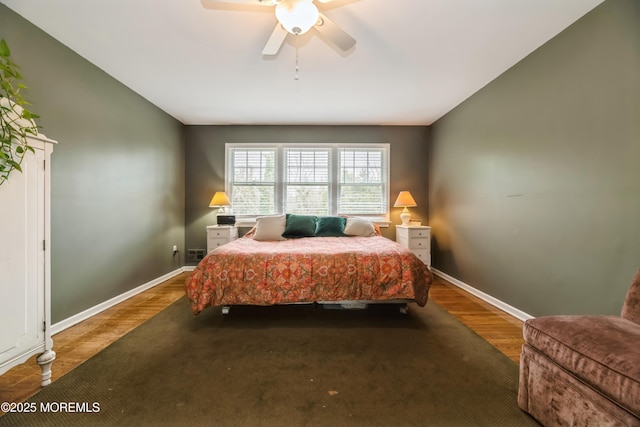 bedroom with baseboards, wood finished floors, and a ceiling fan