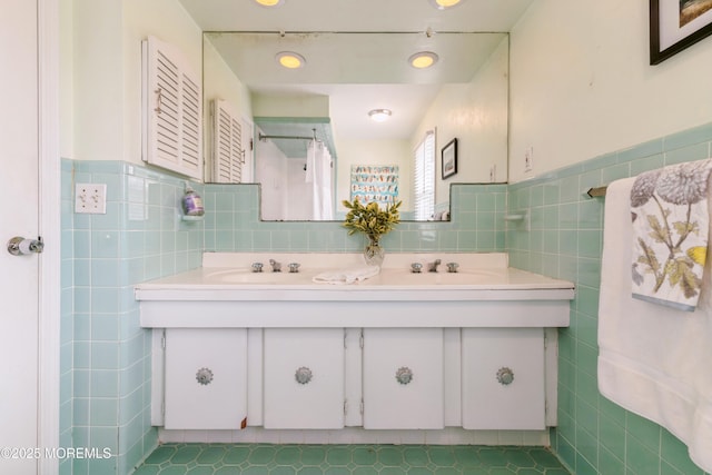 bathroom featuring tile walls, a shower with curtain, and a sink