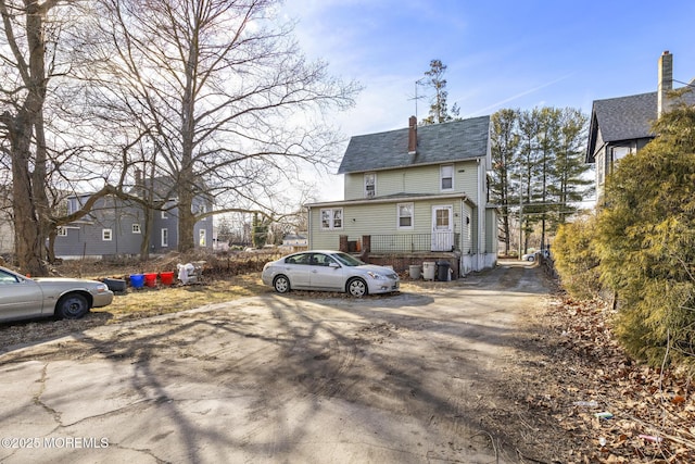 view of front of house featuring a chimney