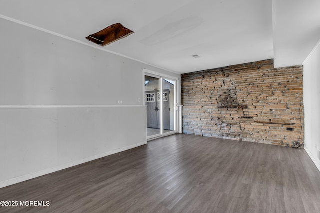 unfurnished room with ornamental molding, wood finished floors, and baseboards