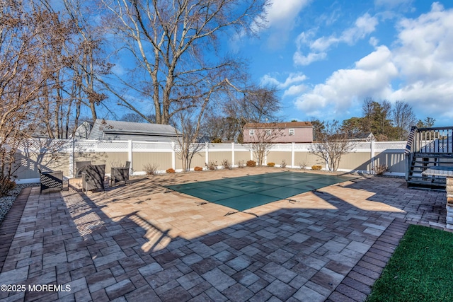 view of swimming pool featuring a patio area, a fenced backyard, and a fenced in pool