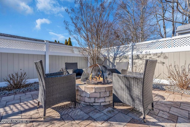 view of patio / terrace featuring an outdoor fire pit and a fenced backyard