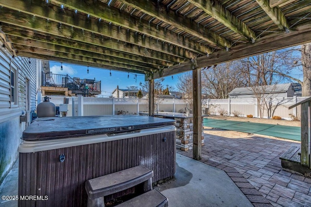 view of patio featuring a hot tub, a fenced in pool, and a fenced backyard