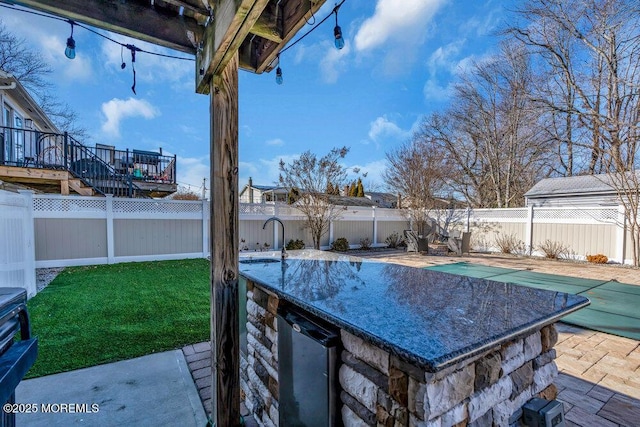 view of patio with a fenced backyard and a sink