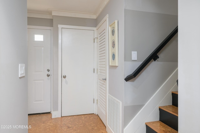 foyer with stairway and visible vents