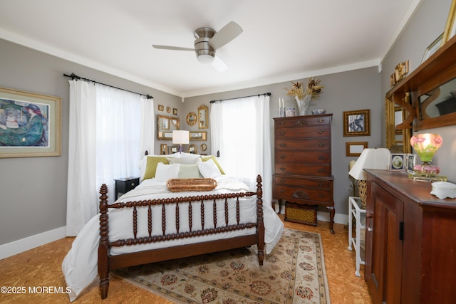 bedroom with baseboards, ceiling fan, and crown molding