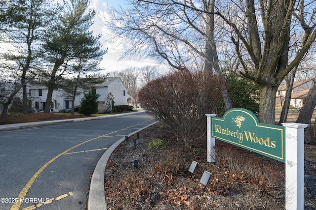 view of street with curbs and a residential view