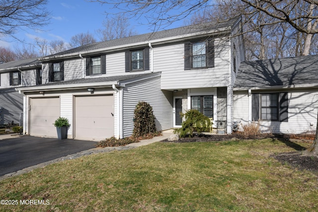 view of front of property featuring aphalt driveway, a garage, a front yard, and roof with shingles