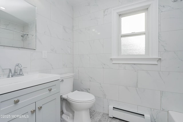 bathroom featuring tile walls, toilet, baseboard heating, vanity, and walk in shower