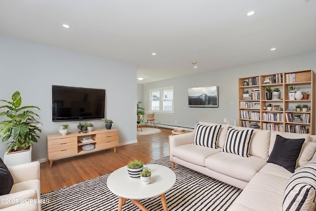 living area with recessed lighting, baseboards, baseboard heating, and wood finished floors