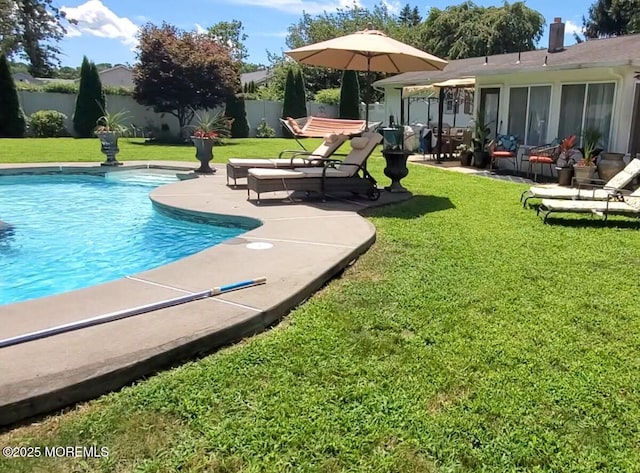 view of pool featuring a yard, a patio, a fenced in pool, and a fenced backyard