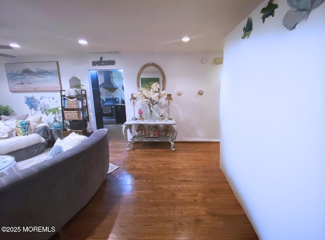 hall with recessed lighting, visible vents, and wood finished floors