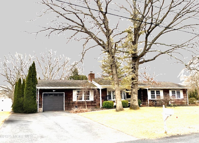 single story home with an attached garage, driveway, and a chimney