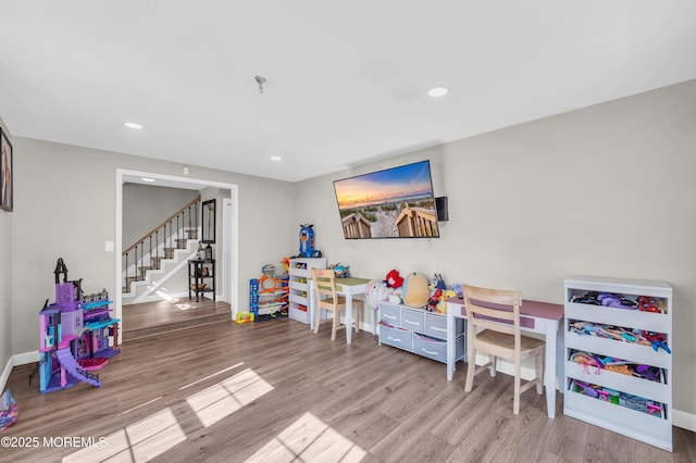 playroom with baseboards, wood finished floors, and recessed lighting