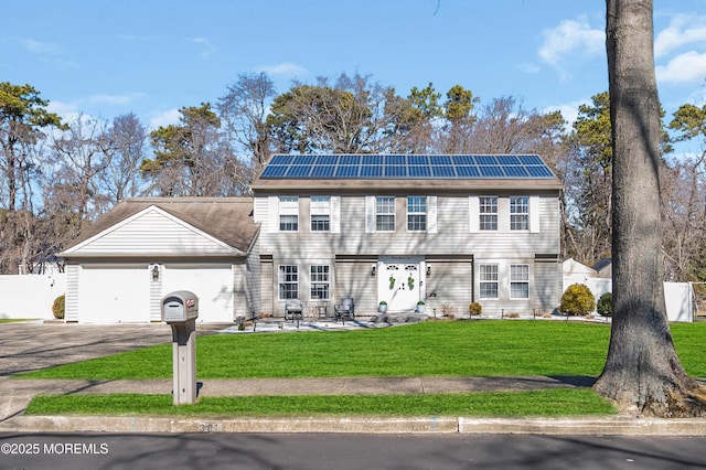 colonial home featuring roof mounted solar panels, an attached garage, driveway, and a front lawn