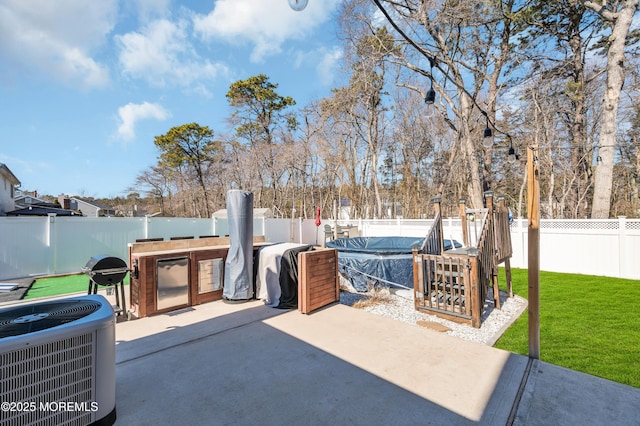 view of patio / terrace with a fenced backyard, grilling area, and central AC