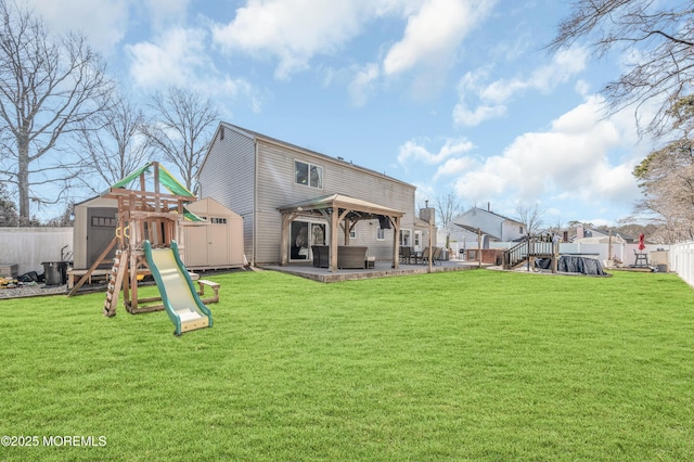 back of property with a patio area, a playground, a yard, and a gazebo