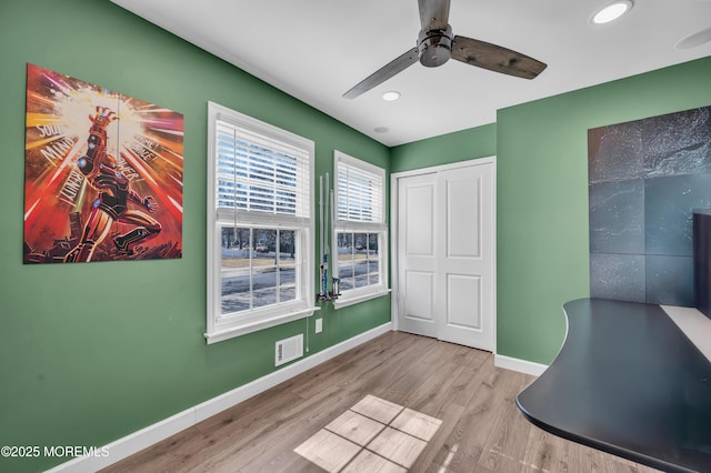 home office with recessed lighting, wood finished floors, visible vents, and baseboards