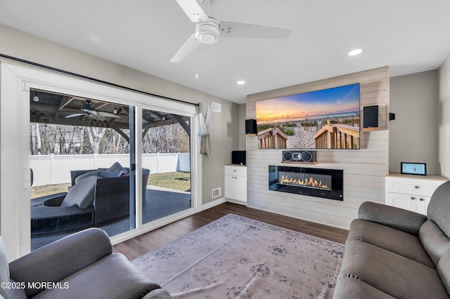 living area with recessed lighting, a large fireplace, wood finished floors, visible vents, and a ceiling fan