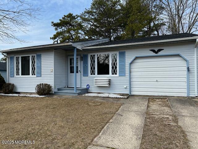 single story home featuring an attached garage and driveway