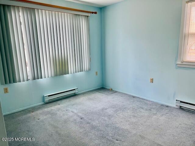 empty room featuring carpet floors, a baseboard radiator, and baseboards