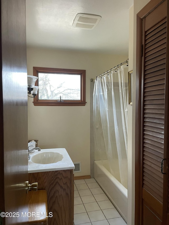 bathroom with shower / tub combo with curtain, a closet, visible vents, vanity, and tile patterned flooring