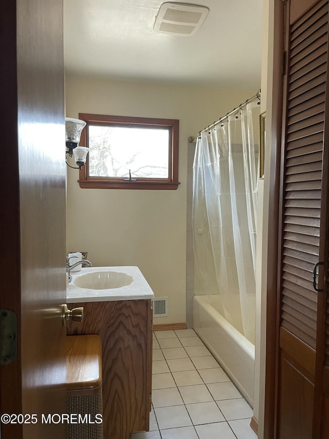 bathroom with shower / tub combo, visible vents, vanity, and tile patterned floors