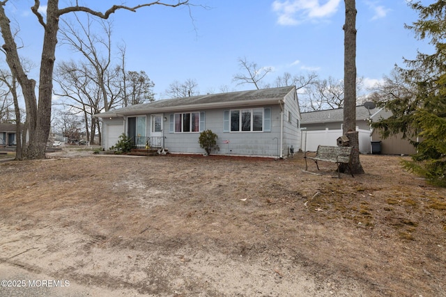 view of front of home featuring a garage and fence