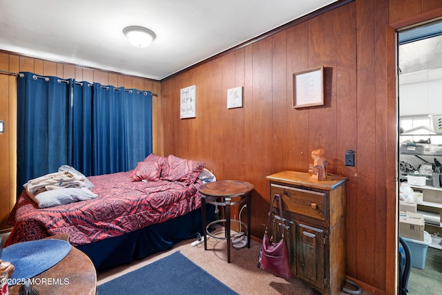 bedroom featuring carpet flooring and wooden walls