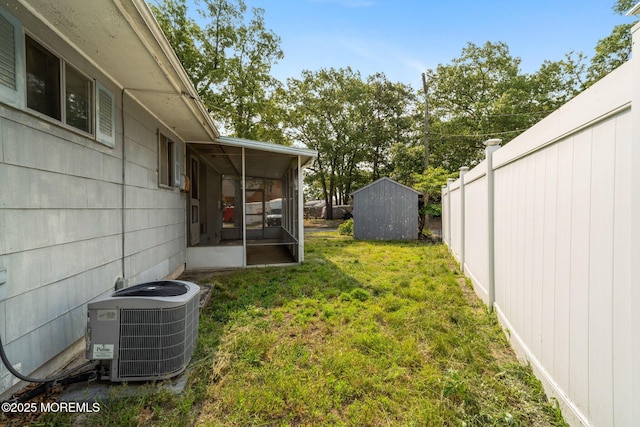 625 Twin River Dr, Forked River, NJ 08731 - view of green lawn with central AC unit, a sunroom, and a storage shed