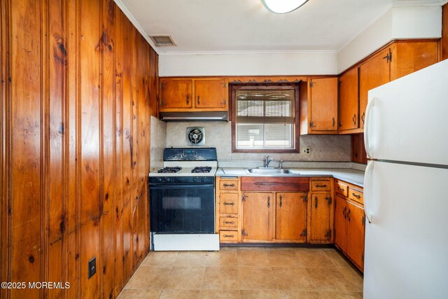 625 Twin River Dr, Forked River, NJ 08731 - kitchen with white appliances, a sink, under cabinet range hood, brown cabinetry, and light countertops