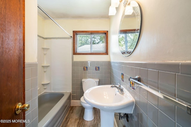 625 Twin River Dr, Forked River, NJ 08731 - bathroom with toilet, tile walls, wood finished floors, shower / bathtub combination, and a wainscoted wall