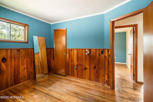625 Twin River Dr, Forked River, NJ 08731 - unfurnished bedroom featuring wood finished floors, a wainscoted wall, wood walls, and crown molding