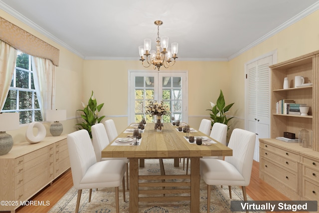 dining area with a chandelier, ornamental molding, and light wood-type flooring