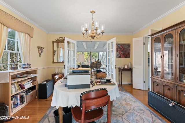 dining space with ornamental molding, a healthy amount of sunlight, and wood finished floors