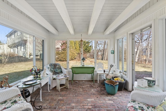 sunroom featuring beam ceiling