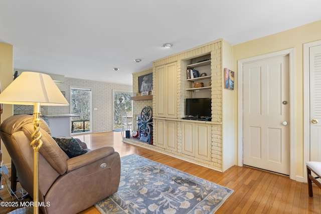 living room with light wood-type flooring and a fireplace