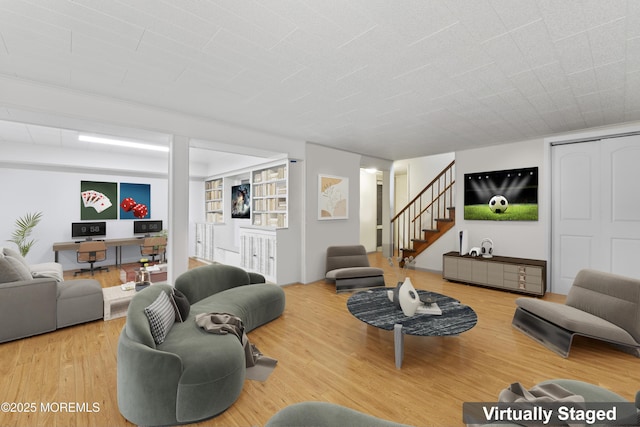 living room featuring stairs and wood finished floors