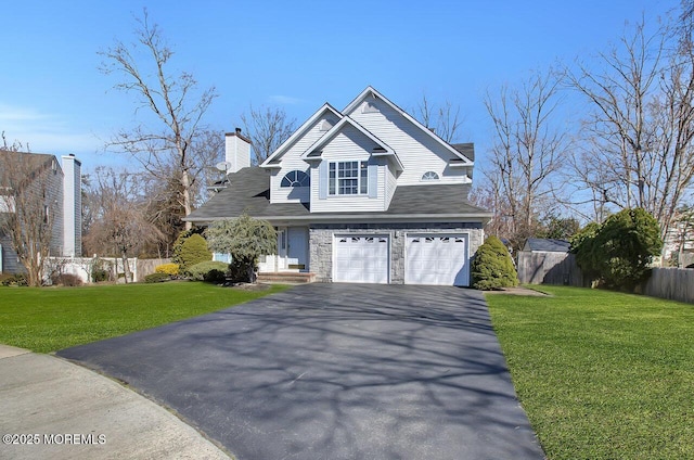 view of front of home featuring aphalt driveway, a chimney, a front yard, and fence