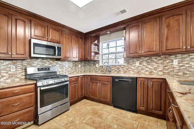 kitchen with visible vents, appliances with stainless steel finishes, decorative backsplash, and light stone counters