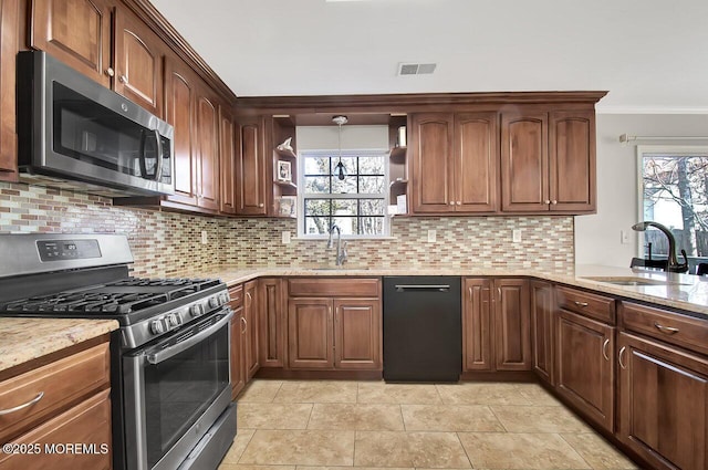 kitchen featuring crown molding, open shelves, stainless steel appliances, visible vents, and a sink