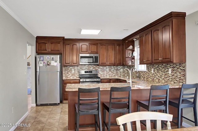 kitchen featuring light stone counters, open shelves, stainless steel appliances, backsplash, and a peninsula