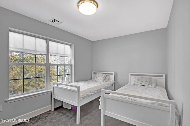 bedroom with carpet flooring, visible vents, and baseboards